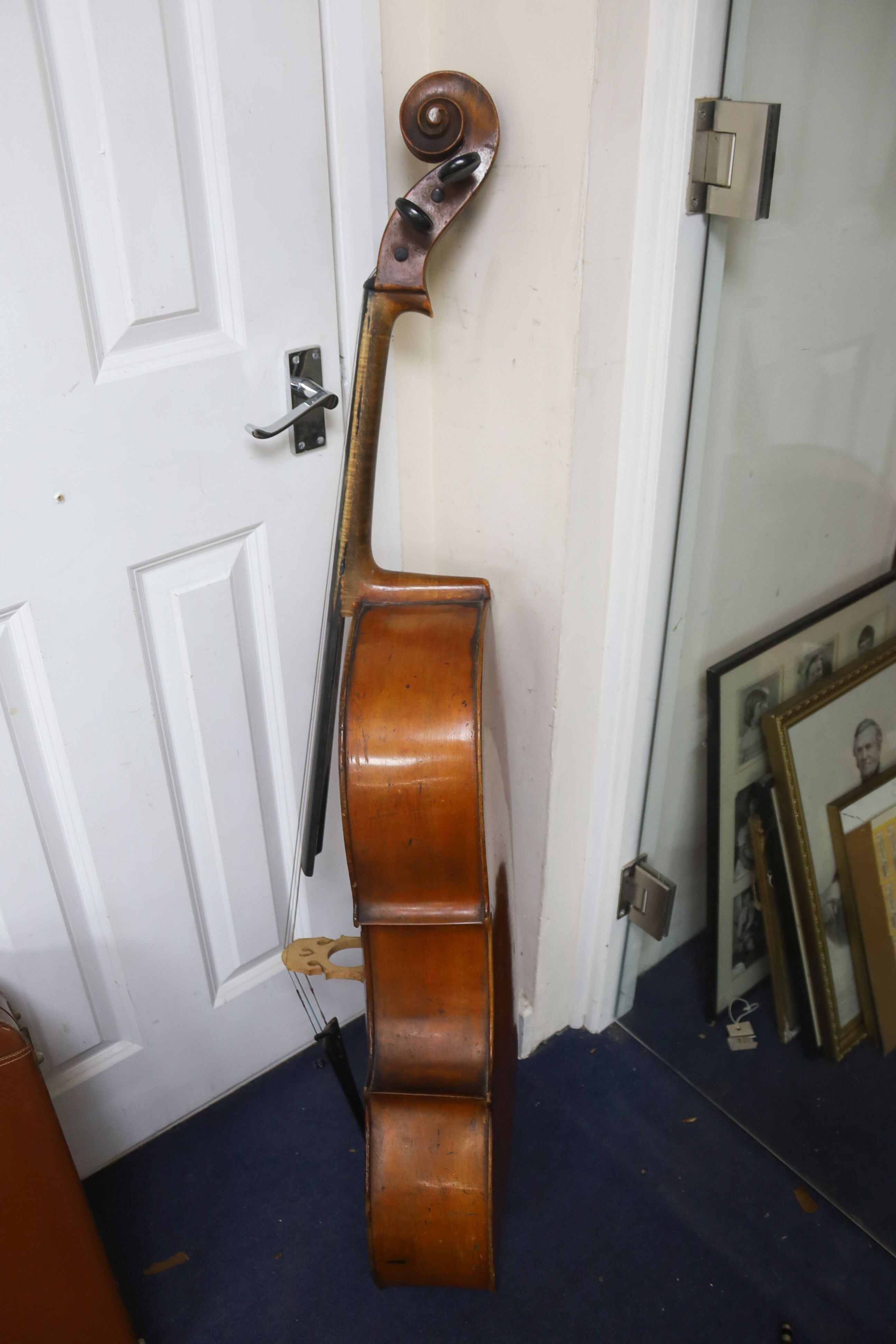 Early 20th century German cello and bow, the back measuring 75cm excluding the button